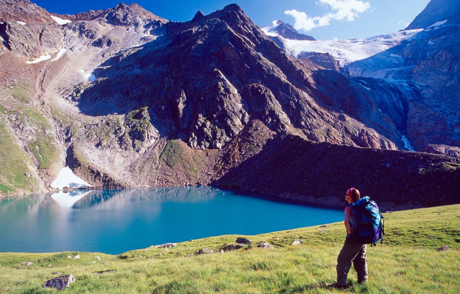Walker looking over the Grunasee and Wilder Freiger, Stubai Hohenweg, Tirol, Austria. Walker looking over the Grunasee and Wilder Freiger, Stubai Hohenweg, Tirol, Austria.