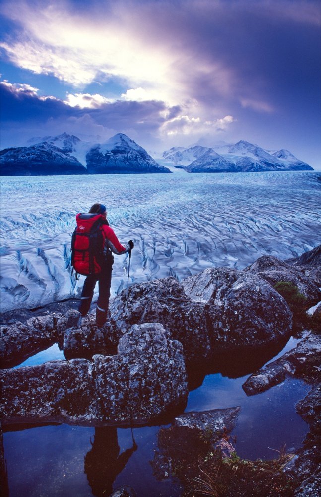 Trekker looking over Glacier Grey, Paine Circuit, Torres del Paine NP, Patagonia, Chile.