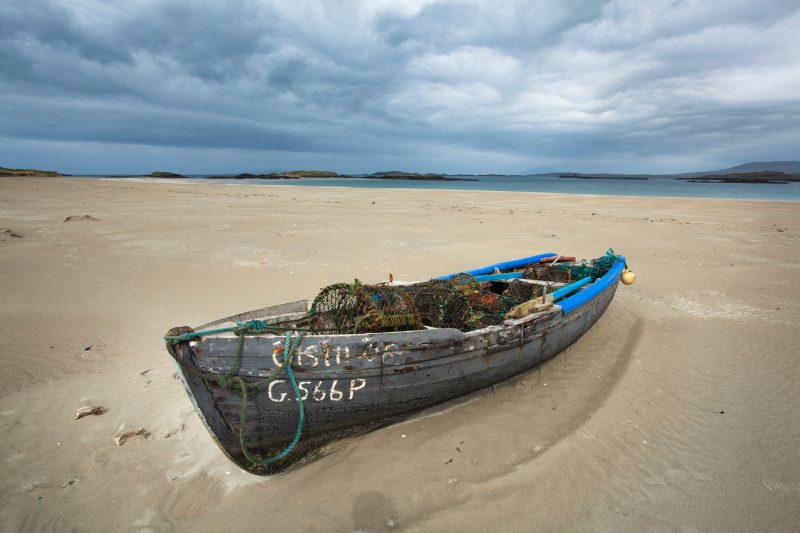 Old currach on Glassilaun Beach, Connemara, County Galway, Ireland.