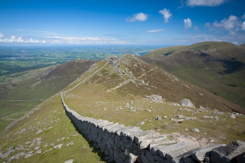 The Mourne Wall ascending the steep slopes of Slieve Bearnagh, Mourne Mountains, Co Down, Northern Ireland.