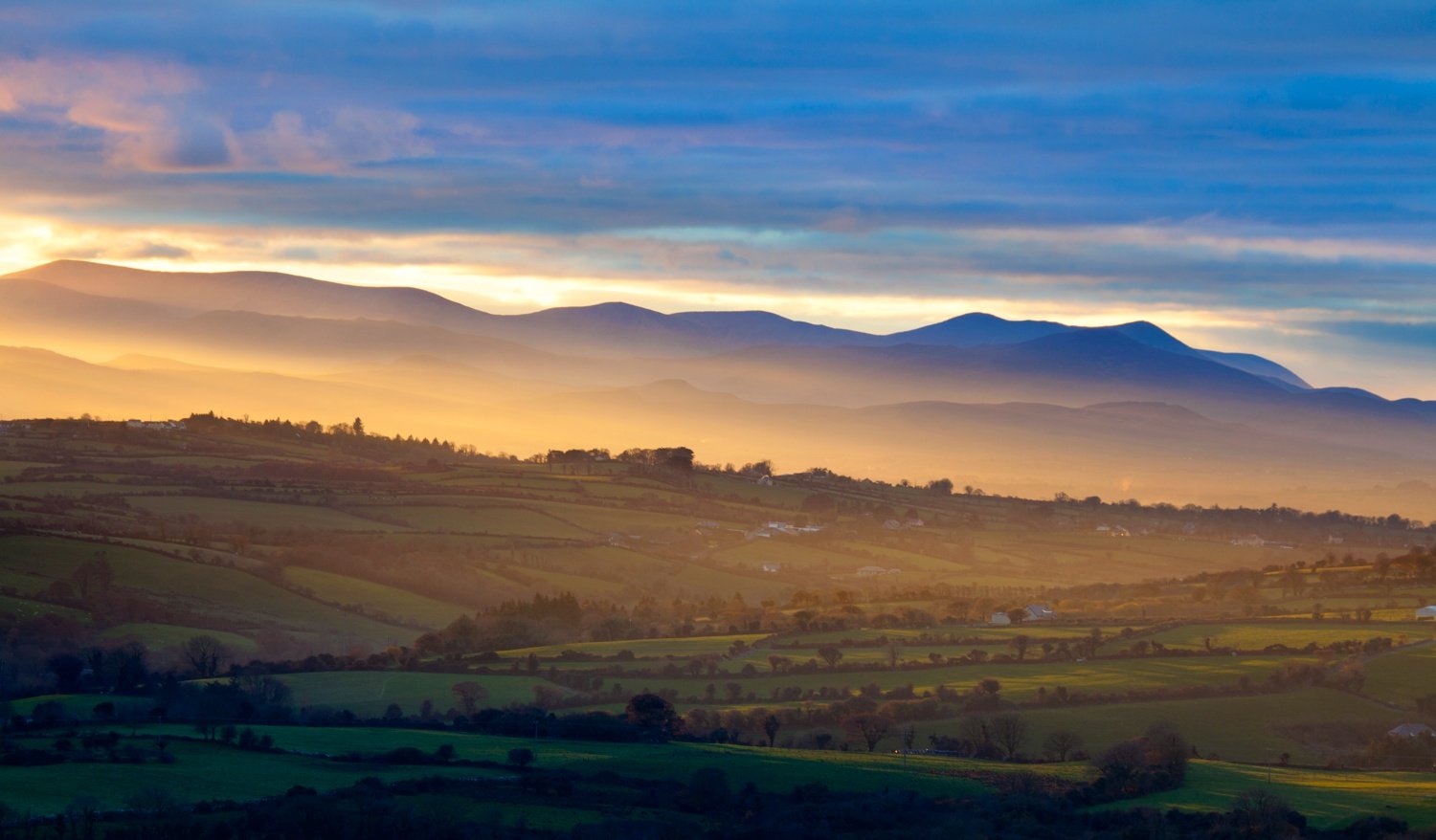 Looking across farmland near Killarney towards the hills of Iveragh, County Kerry, Ireland. Looking across farmland near Killarney towards the hills of Iveragh, County Kerry, Ireland.