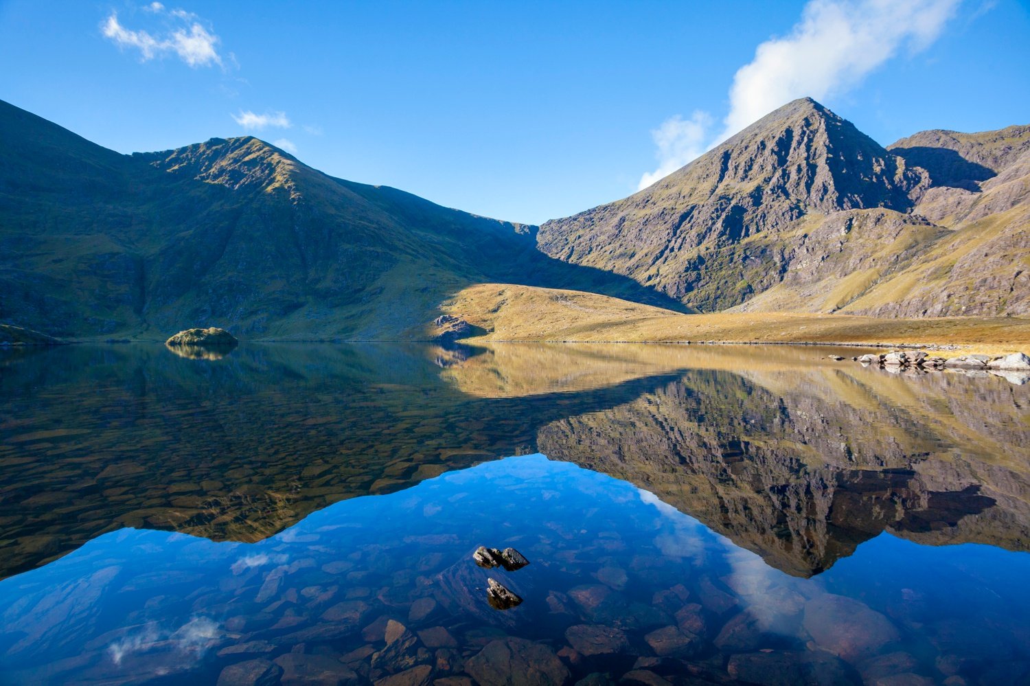 Carrauntoohil reflected in Lough Callee, Hag's Glen, MacGillycuddy's Reeks, County Kerry, Ireland. Carrauntoohil reflected in Lough Callee, Hag's Glen, MacGillycuddy's Reeks, County Kerry, Ireland.