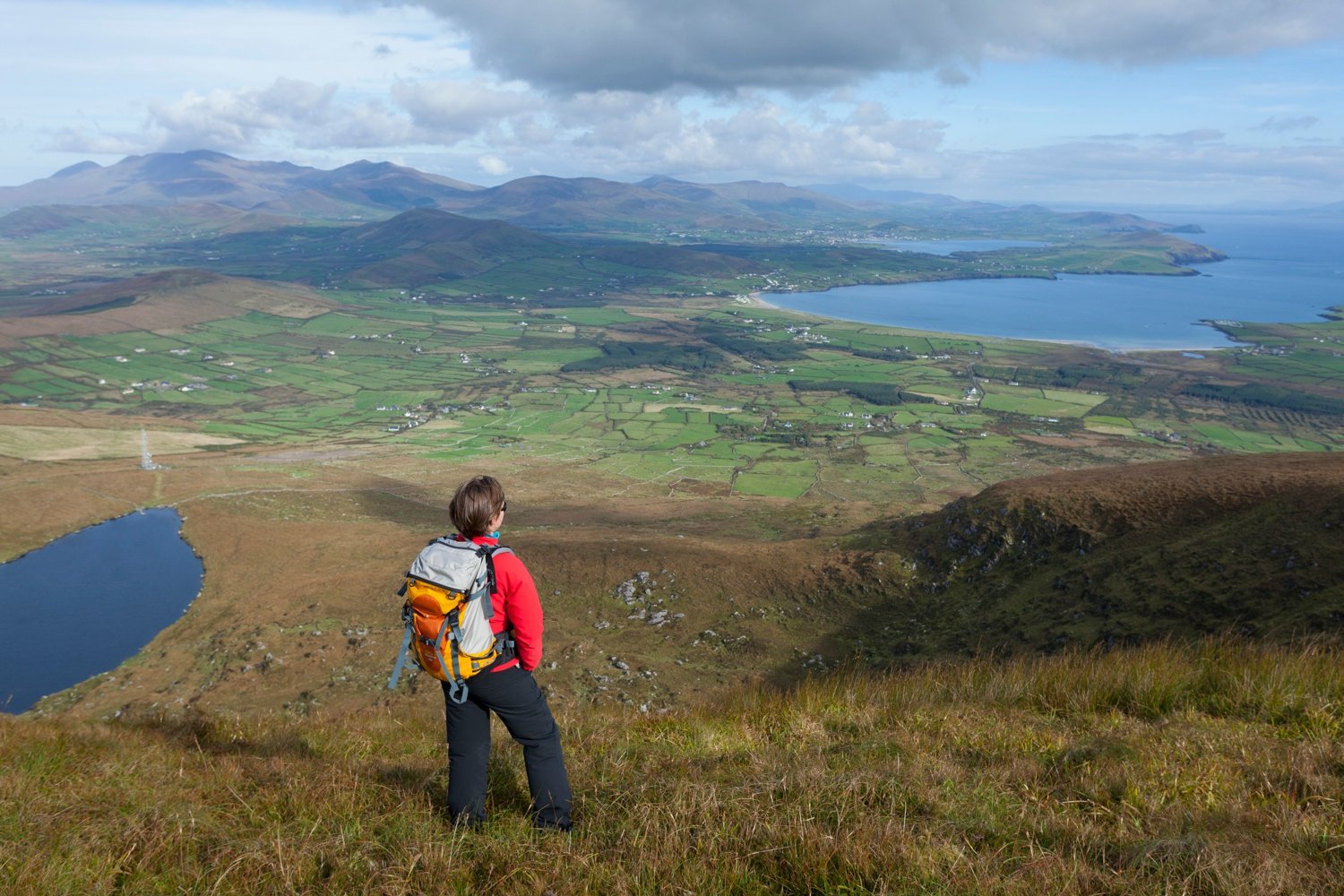 Walker looking across the Dingle Peninsula from Eagle Mountain, County Kerry, Ireland. Walker looking across the Dingle Peninsula from Eagle Mountain, County Kerry, Ireland.