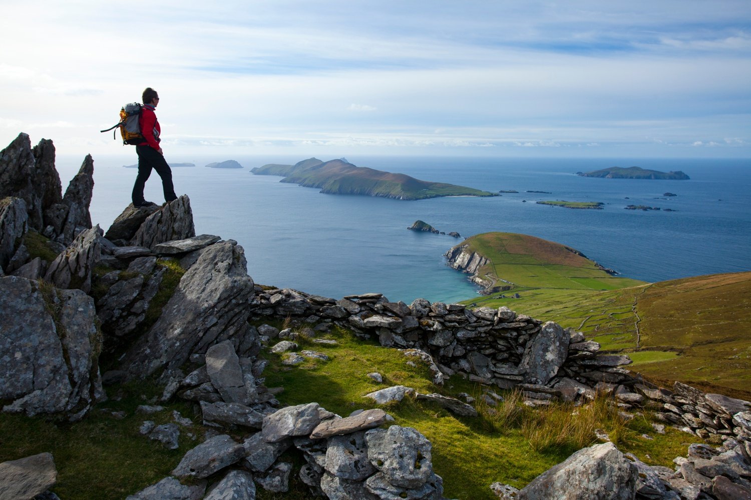 Walker looking across Slea Head and the Blasket Islands from Eagle Mountain, County Kerry, Ireland. Walker looking across Slea Head and the Blasket Islands from Eagle Mountain, County Kerry, Ireland.