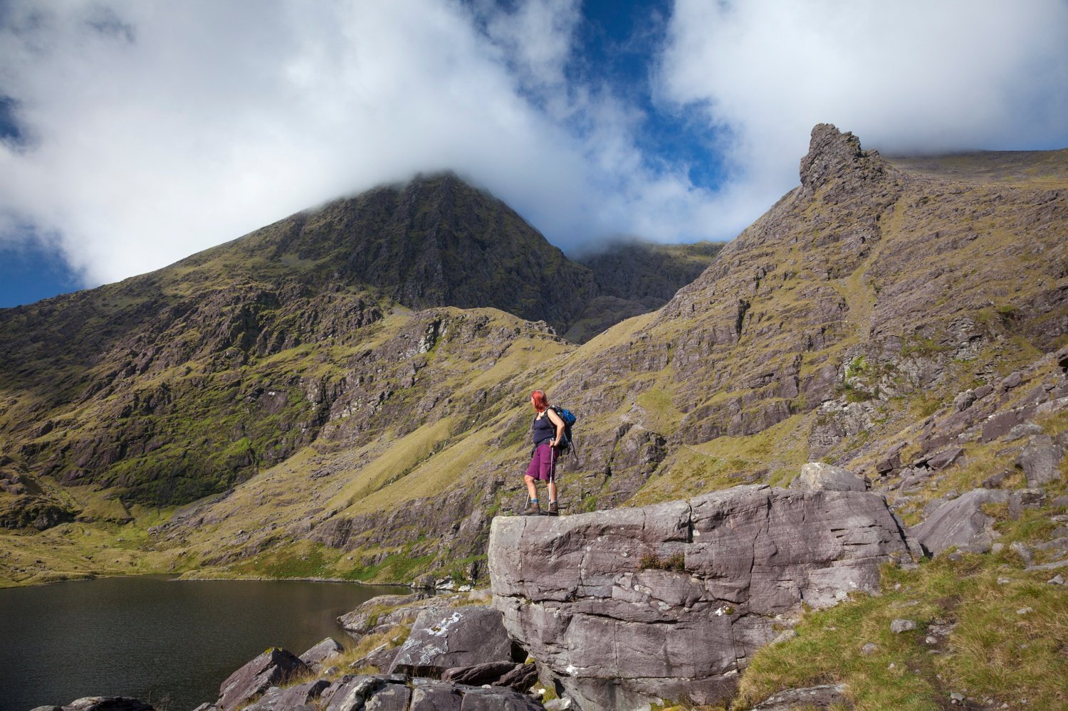 Hiker and Lough Gouragh beneath Carrauntoohil, MacGillycuddy's Reeks, County Kerry, Ireland. Hiker and Lough Gouragh beneath Carrauntoohil, MacGillycuddy's Reeks, County Kerry, Ireland.